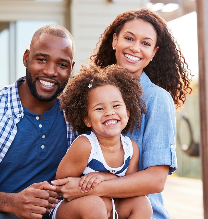 Family smiling after seeing Cigna dentist in Beaverton