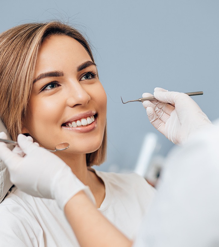 Dentist talking to a female patient