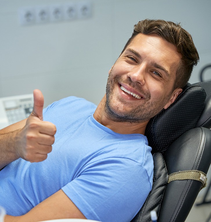 Male dental patient making thumbs up gesture