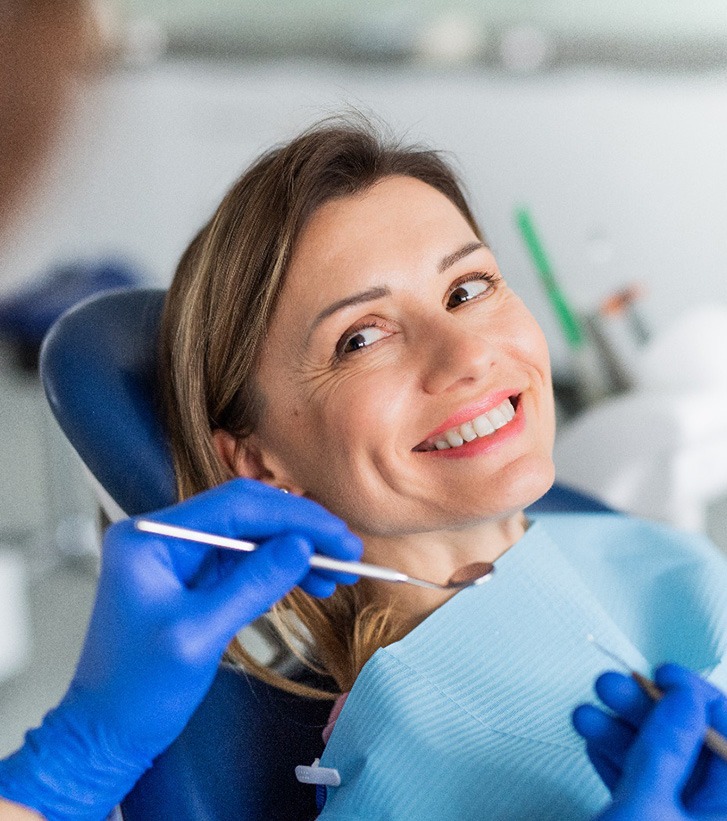 Dental patient smiling at dental team member